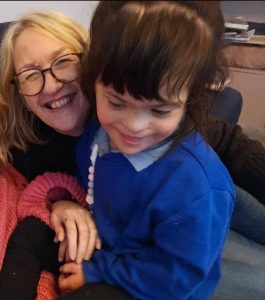 A picture of a smiling woman with her granddaughter